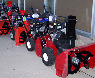 A row of red Toro snowthrowers