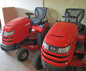 Two red Toro lawn tractors