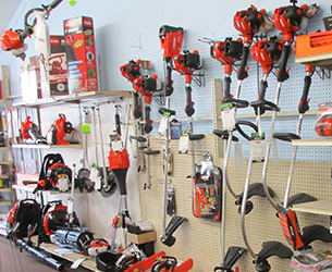 A wall with hanging power string trimmers