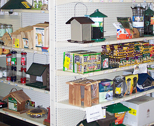 Store shelves with bird houses, bird feeders, and suet cages