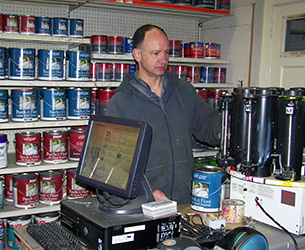 A man color-matching and mixing paint